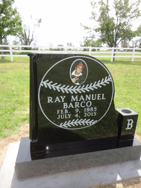 A headstone for Ray Barco