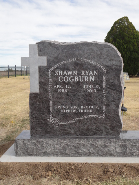 A headstone with a cross