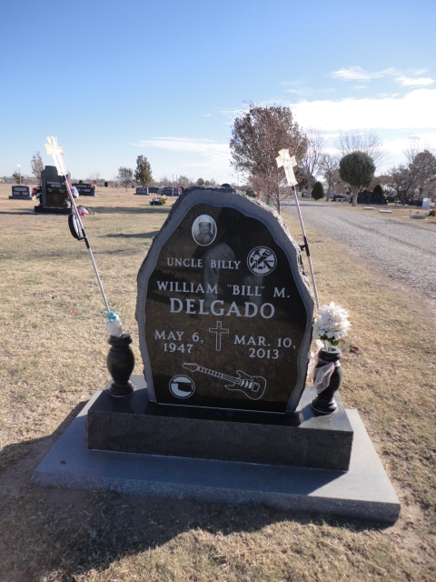 A headstone with a guitar design