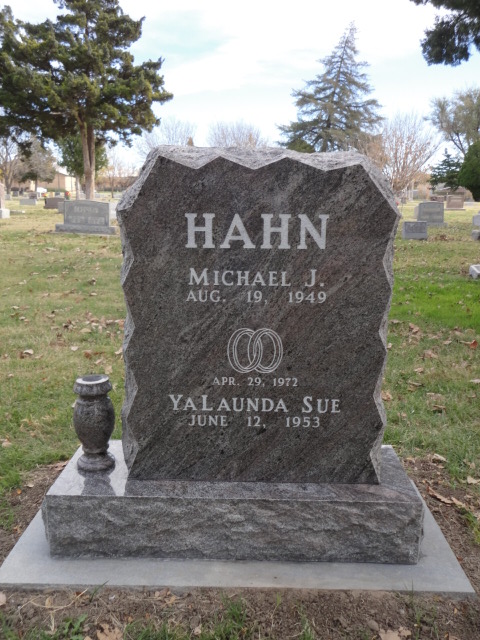 A jagged headstone with a design showing two wedding rings
