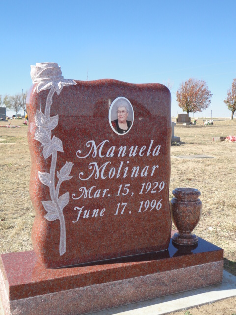 An orange headstone with white flower designs