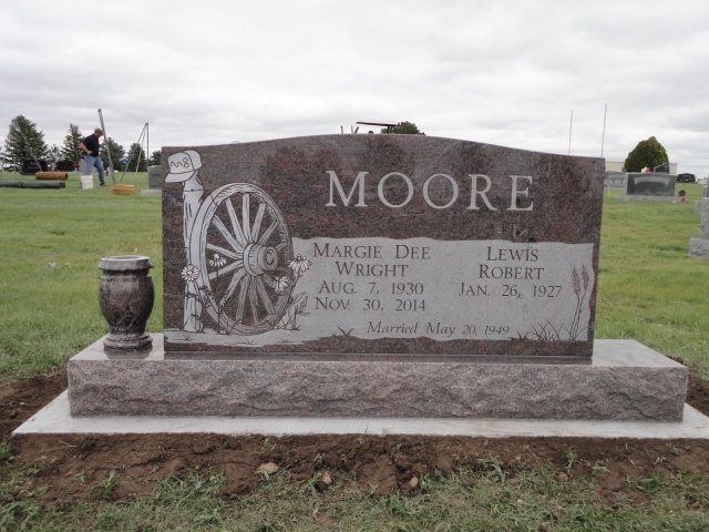 A monument for Margie and Lewis Moore with a wheel design