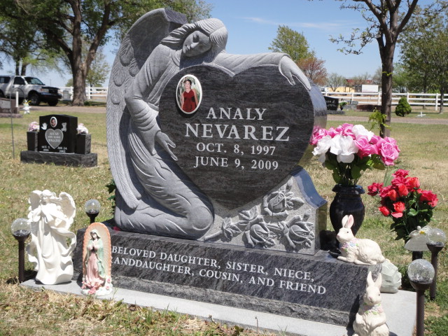 A heart-shaped monument with Analy Nevarez with angel statues